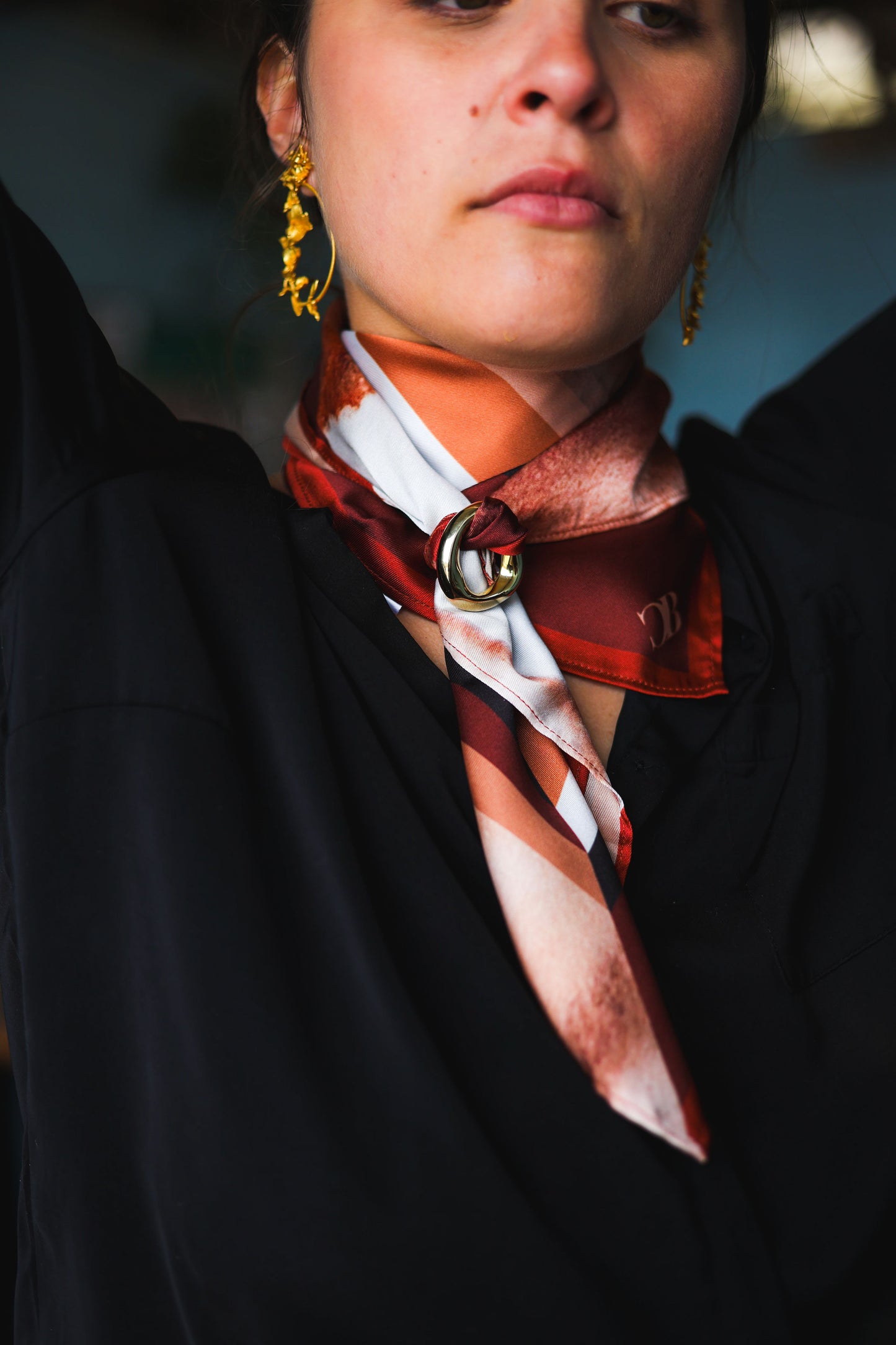 Woman wearing a patterned scarf with a blurred background